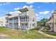 Two-story building with multiple balconies and screened porches at 1100 Possum Trot Rd. # C-101, North Myrtle Beach, SC 29582