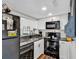 Modern galley kitchen with black appliances and granite countertops at 1100 Possum Trot Rd. # C-101, North Myrtle Beach, SC 29582
