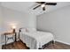 Bright bedroom with ceiling fan, wood floors and striped bedding at 1100 Possum Trot Rd. # C-101, North Myrtle Beach, SC 29582