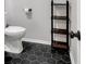 Small bathroom with hexagon tile floor and floating shelves at 1100 Possum Trot Rd. # C-101, North Myrtle Beach, SC 29582