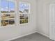 Well-lit bedroom with two windows and grey carpet at 3059 Deerberry Place, Longs, SC 29568
