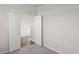 Simple bedroom with neutral walls, carpet, and double doors leading into another room at 3059 Deerberry Place, Longs, SC 29568