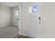 Bright entryway with white door and view into an adjacent room with carpet at 3059 Deerberry Place, Longs, SC 29568