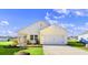 Beautiful yellow and white exterior of a new home with a two-car garage and landscaping at 3059 Deerberry Place, Longs, SC 29568