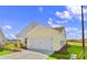 Rear view of a new home showcasing its exterior features and landscaping at 3059 Deerberry Place, Longs, SC 29568