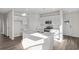 Modern kitchen with white cabinets, quartz countertops, and stainless steel appliances at 3059 Deerberry Place, Longs, SC 29568
