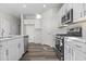 Modern kitchen with white cabinets, quartz countertops, and stainless steel appliances at 3059 Deerberry Place, Longs, SC 29568