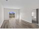Spacious living room with vinyl plank flooring and sliding glass doors leading outside at 3059 Deerberry Place, Longs, SC 29568