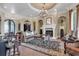 Elegant living room with fireplace, ornate chandelier, and comfortable seating at 1563 Cadiz Dr., Myrtle Beach, SC 29579