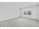 Bright bedroom with grey carpet and neutral walls at 1919 Copper Creek Loop, Longs, SC 29568