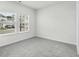 Bright bedroom featuring grey carpeting and two large windows at 1919 Copper Creek Loop, Longs, SC 29568