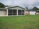 Home exterior showcasing a large screened porch and yard at 3922 Spruce Dr. # 3922, Myrtle Beach, SC 29577