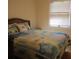 Bright bedroom with a cheerful quilt and wicker headboard at 3922 Spruce Dr. # 3922, Myrtle Beach, SC 29577