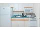 Compact kitchen featuring white appliances and wood cabinets at 2207 S Ocean Blvd. # 1516, Myrtle Beach, SC 29577
