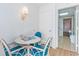 Small dining area with a round table and four teal chairs at 2207 S Ocean Blvd. # 1516, Myrtle Beach, SC 29577