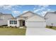 New construction home with a two-car garage and landscaped yard at 352 Clear Lake Dr., Conway, SC 29526