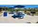 Outdoor grilling area with picnic tables and umbrellas at 669 Retreat Beach Circle # C2G, Pawleys Island, SC 29585