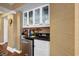 Convenient wet bar with granite countertop, cabinets, and mini-fridge at 669 Retreat Beach Circle # C2G, Pawleys Island, SC 29585