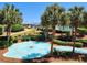 Relaxing pond with fountain, palm trees, and landscaping at 669 Retreat Beach Circle # C2G, Pawleys Island, SC 29585