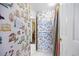 Charming bathroom with birdcage wallpaper and shower at 669 Retreat Beach Circle # C2G, Pawleys Island, SC 29585