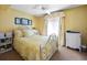 Bedroom with yellow walls and full bed at 669 Retreat Beach Circle # C2G, Pawleys Island, SC 29585