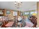 Elegant dining room with a glass table and chandelier, offering views to living areas at 669 Retreat Beach Circle # C2G, Pawleys Island, SC 29585