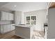 Modern kitchen featuring white cabinets, granite countertops and island at 310 Chaff Ct., Georgetown, SC 29440