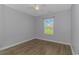 Bedroom with wood-look floors and a window with natural light at 1616 Sapphire Dr., Longs, SC 29568