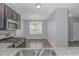 Kitchen features granite countertops, stainless steel appliances, and dark wood cabinets at 1616 Sapphire Dr., Longs, SC 29568