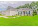 Gray house with a white garage and landscaped lawn at 1616 Sapphire Dr., Longs, SC 29568