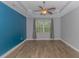 Bright bedroom with blue accent wall and wood-look floors at 1616 Sapphire Dr., Longs, SC 29568