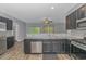Modern kitchen with stainless steel appliances and dark cabinetry at 1616 Sapphire Dr., Longs, SC 29568