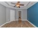 Primary bedroom with wood-look floors and access to bathroom at 1616 Sapphire Dr., Longs, SC 29568