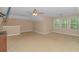 Large bonus room with carpet, ceiling fan, and multiple windows at 1616 Sapphire Dr., Longs, SC 29568