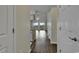 View down a hallway that opens to a living room and balcony at 5040 Windsor Green Way # 302, Myrtle Beach, SC 29579