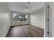 Bedroom with wood-look floors, large window, and ceiling fan at 5040 Windsor Green Way # 302, Myrtle Beach, SC 29579