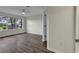Bedroom with wood-look floors, large window, and ceiling fan at 5040 Windsor Green Way # 302, Myrtle Beach, SC 29579
