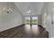 Spacious living room with vaulted ceiling, wood-look flooring and access to balcony at 5040 Windsor Green Way # 302, Myrtle Beach, SC 29579
