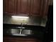 Kitchen sink with dark countertop and wood cabinets at 1501 S Ocean Blvd. # 848, Myrtle Beach, SC 29577