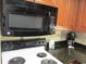 White stove and black microwave in kitchen at 1501 S Ocean Blvd. # 848, Myrtle Beach, SC 29577
