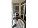 Private balcony with table and chairs, offering partial ocean view at 2701 S Ocean Blvd. # 1410, North Myrtle Beach, SC 29582
