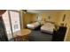 Two beds, small table, and balcony access at 2701 S Ocean Blvd. # 1410, North Myrtle Beach, SC 29582