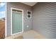 Small back porch with light green door and gray siding at 1080 Flintshire Dr., Myrtle Beach, SC 29579