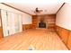 Living room with wood flooring, built-in shelving, and a stone fireplace at 553 Martin Luther King Rd., Pawleys Island, SC 29585