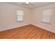 Simple bedroom with hardwood floors and two windows at 553 Martin Luther King Rd., Pawleys Island, SC 29585