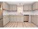 Updated kitchen with gray cabinets and white marble backsplash at 553 Martin Luther King Rd., Pawleys Island, SC 29585