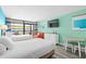 Bright bedroom with two twin beds, a sofa, and balcony access at 1501 S Ocean Blvd. # 904, Myrtle Beach, SC 29577