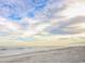 Expansive beach with ocean waves under a cloudy sky at 6001- 1029 S Kings Hwy., Myrtle Beach, SC 29575