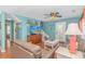 Beach house living room with light blue walls, comfortable seating, and stairs at 6001- 1029 S Kings Hwy., Myrtle Beach, SC 29575