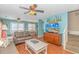 Beach-themed living room with a large TV, comfortable seating, and stairs at 6001- 1029 S Kings Hwy., Myrtle Beach, SC 29575